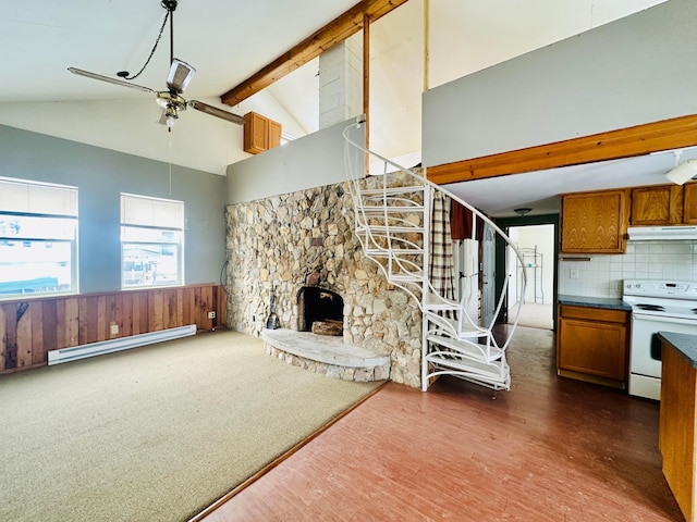 unfurnished living room with wainscoting, ceiling fan, beamed ceiling, baseboard heating, and a fireplace