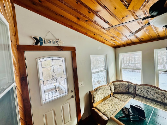 interior space with a ceiling fan, wood ceiling, and vaulted ceiling