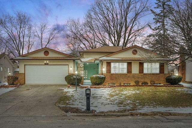 view of front of property with a garage, driveway, and brick siding