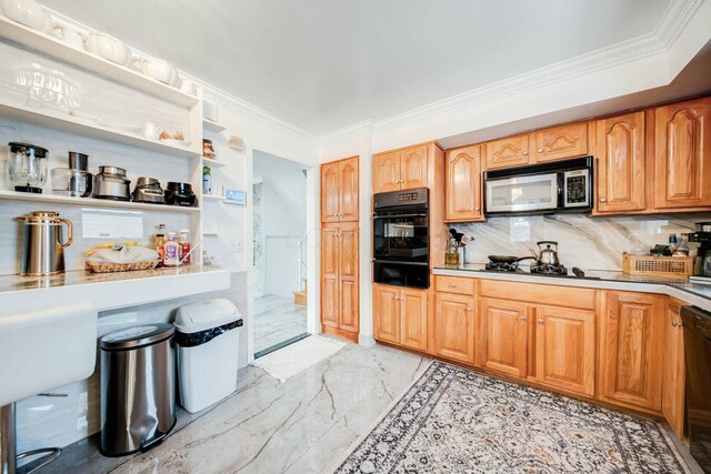 kitchen featuring marble finish floor, ornamental molding, light countertops, a warming drawer, and black appliances