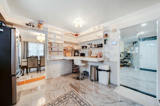 kitchen featuring marble finish floor, crown molding, open shelves, freestanding refrigerator, and a peninsula