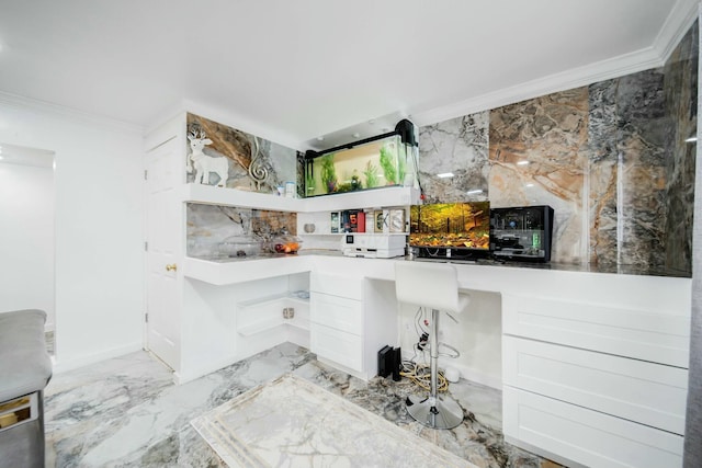 interior space with ornamental molding, marble finish floor, and built in desk