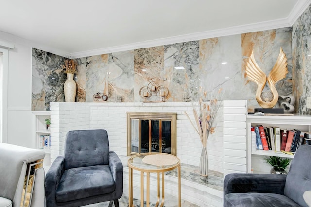 sitting room with a brick fireplace and crown molding