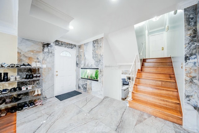 entryway featuring stairs, marble finish floor, and crown molding