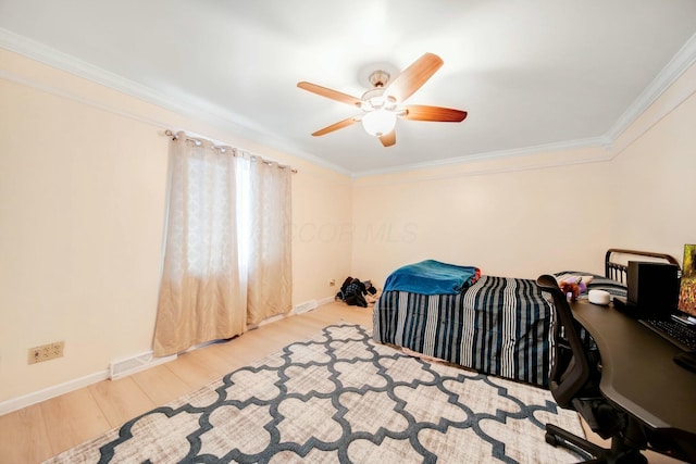 home office featuring ceiling fan, wood finished floors, visible vents, baseboards, and crown molding