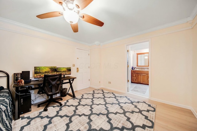 home office with light wood finished floors, baseboards, and crown molding