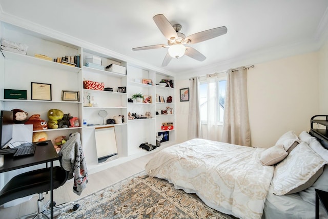 bedroom with ceiling fan, ornamental molding, and wood finished floors