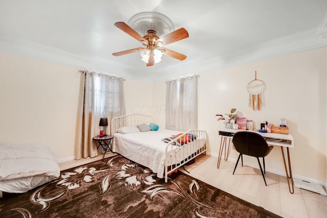 bedroom with ornamental molding, light wood-type flooring, ceiling fan, and baseboards