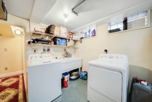 laundry room with laundry area, washer and clothes dryer, and a sink