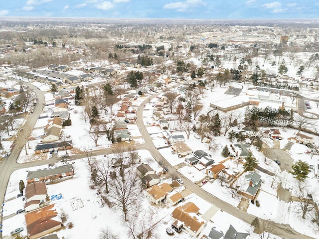 snowy aerial view with a residential view