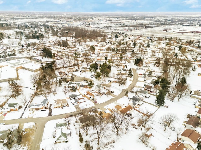 snowy aerial view with a residential view