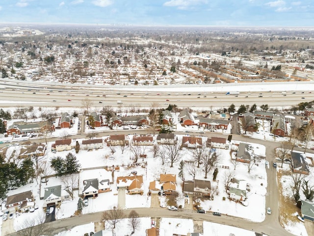 snowy aerial view featuring a residential view