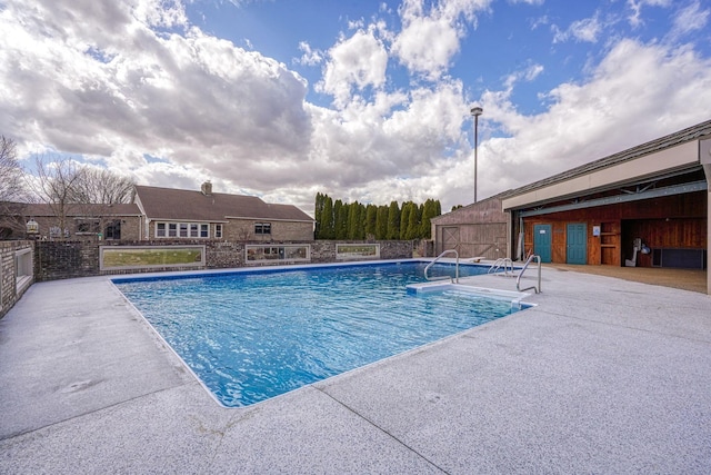 pool with a patio and fence