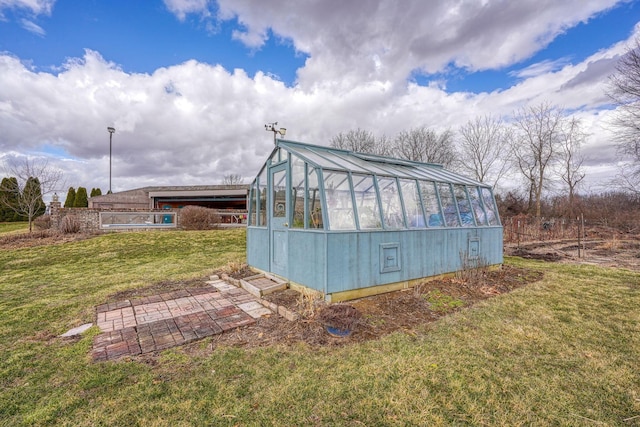 view of greenhouse with a lawn