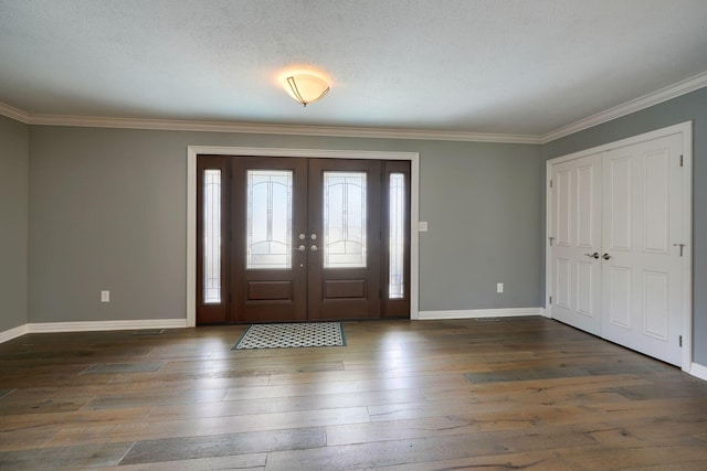 entryway featuring french doors, ornamental molding, hardwood / wood-style flooring, and baseboards