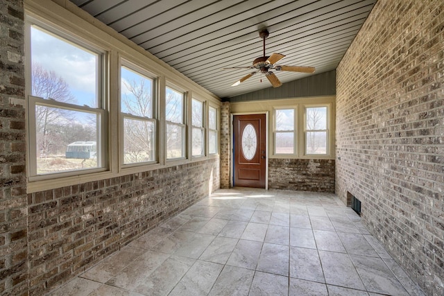 unfurnished sunroom with a ceiling fan and lofted ceiling