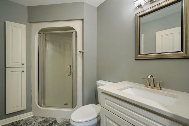 bathroom with a shower stall, toilet, and vanity