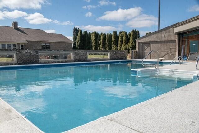 view of pool featuring fence, a fenced in pool, and a patio