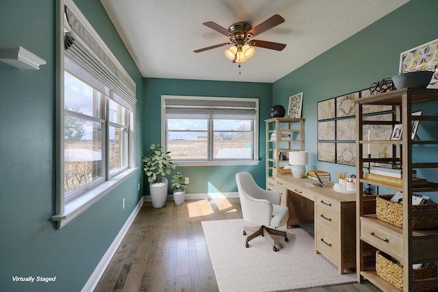 office area featuring a ceiling fan, wood-type flooring, and baseboards