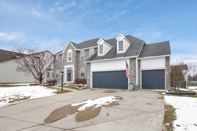 view of front of home featuring a garage, stone siding, a shingled roof, and concrete driveway