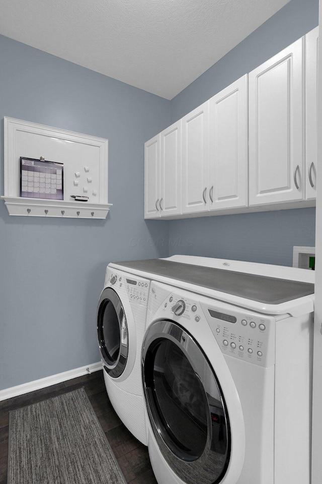 laundry room featuring dark wood-style flooring, cabinet space, independent washer and dryer, and baseboards