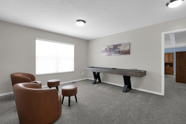 playroom with carpet flooring, a textured ceiling, and baseboards