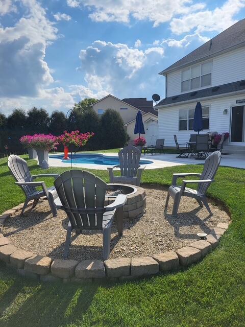 view of yard featuring an outdoor fire pit, a patio area, and an outdoor pool