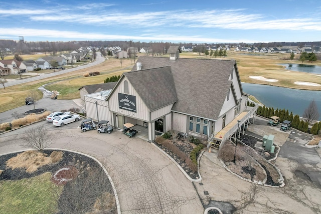 drone / aerial view featuring a water view and a residential view