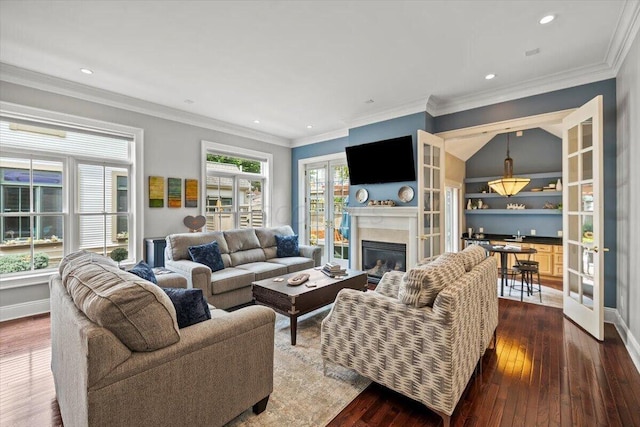 living room with recessed lighting, dark wood-type flooring, baseboards, ornamental molding, and a glass covered fireplace