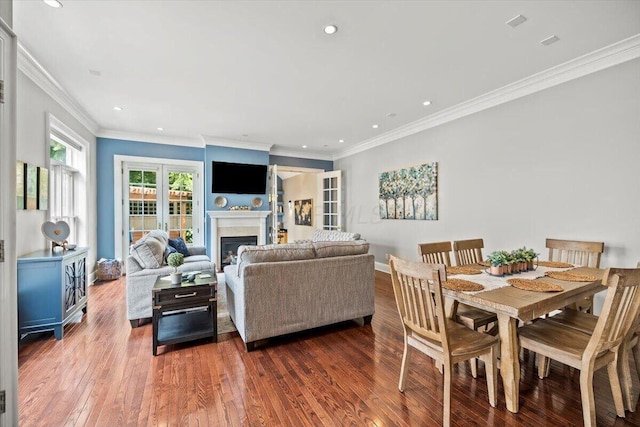 interior space with recessed lighting, a fireplace, baseboards, and wood finished floors