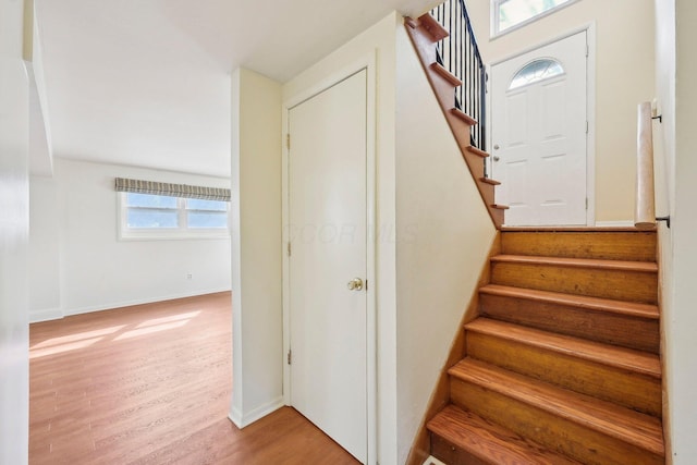 stairway featuring wood finished floors and baseboards