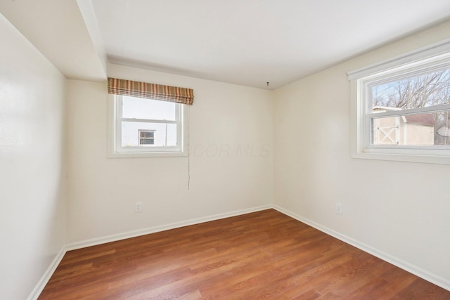 unfurnished room featuring wood finished floors and baseboards