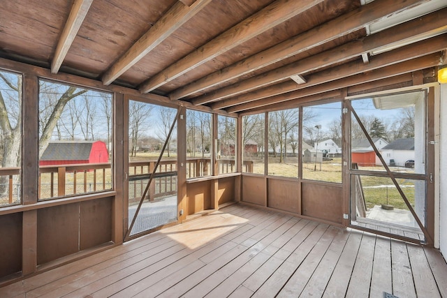 unfurnished sunroom with wooden ceiling and beam ceiling