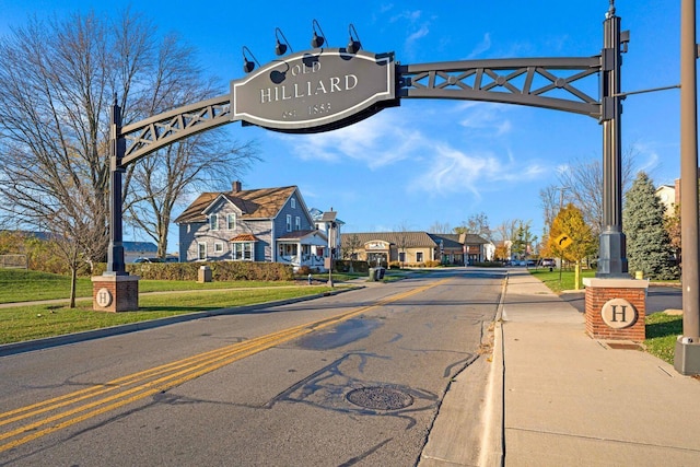 view of street featuring a residential view and curbs