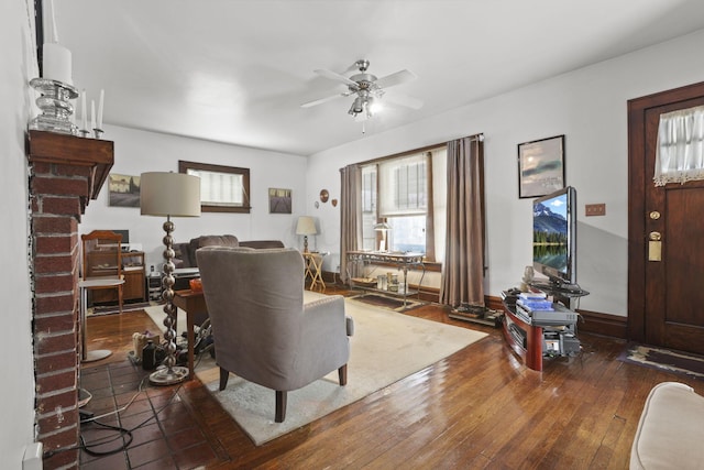 living room featuring ceiling fan and dark wood-type flooring