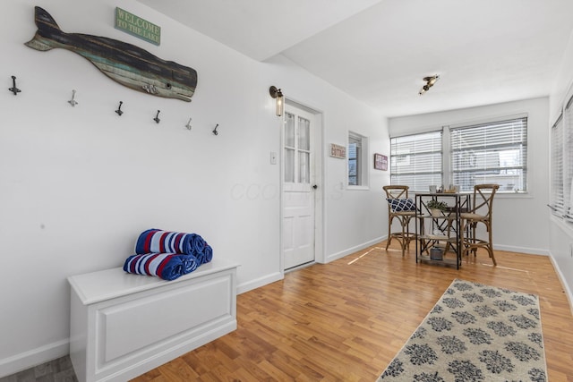 dining room featuring baseboards and light wood finished floors