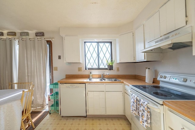 kitchen with light floors, white cabinetry, a sink, white appliances, and under cabinet range hood