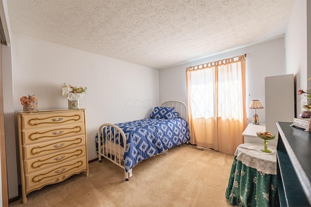 bedroom with carpet floors and a textured ceiling