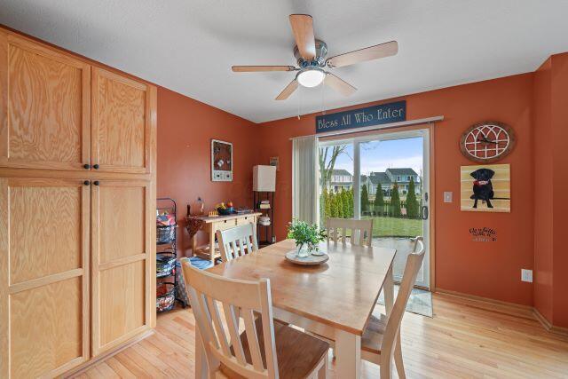 dining area featuring light wood-type flooring and a ceiling fan