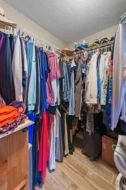 walk in closet featuring light wood finished floors