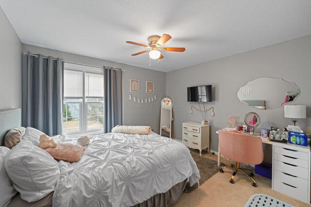 bedroom featuring ceiling fan and light colored carpet