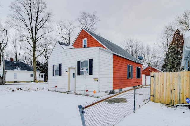 bungalow-style home featuring cooling unit and fence