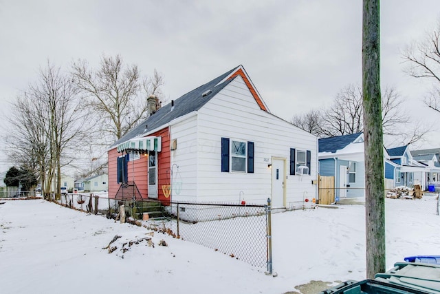 bungalow-style house with a chimney and cooling unit