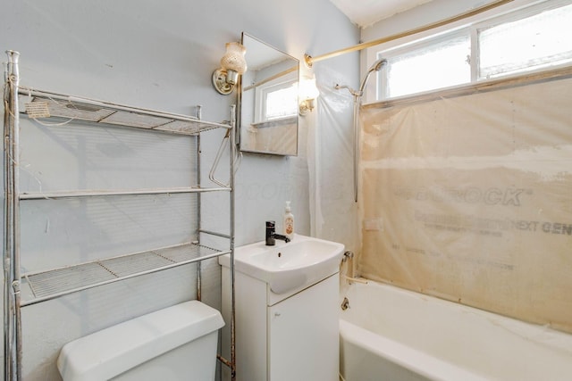 bathroom featuring vanity, bathtub / shower combination, and toilet