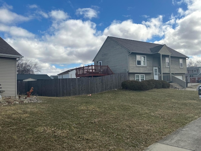 view of property exterior featuring a yard and fence