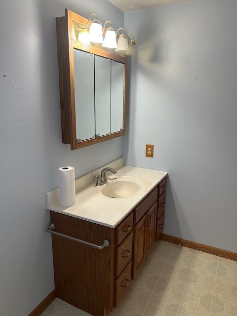 bathroom featuring baseboards and vanity