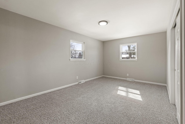 unfurnished bedroom featuring visible vents, baseboards, carpet, and a closet