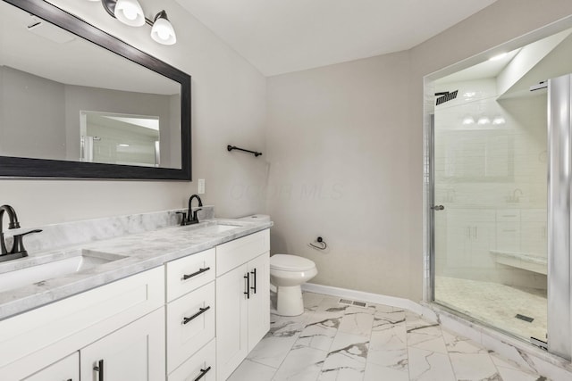 bathroom featuring a sink, baseboards, marble finish floor, and a stall shower