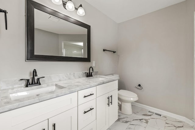 bathroom with toilet, baseboards, marble finish floor, and a sink