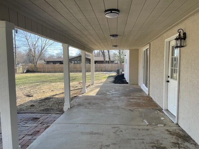 view of patio / terrace featuring central AC and fence